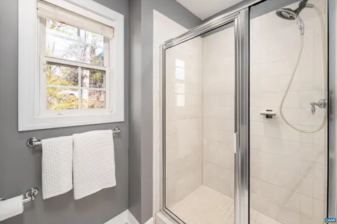 a bathroom with a glass shower door