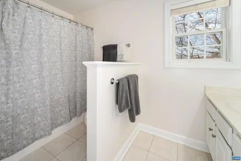 a bathroom with a shower and a sink