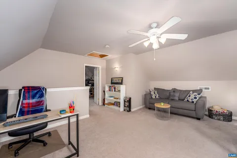 a living room with furniture and a gym machine