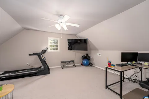 a room with gym equipment and a flat screen tv