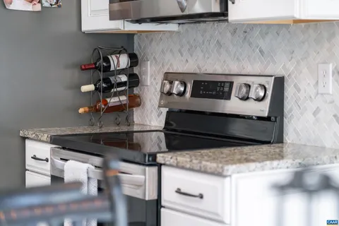 a kitchen with a stove and a cabinets