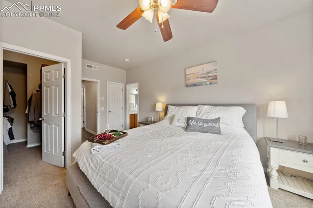 a bedroom with a bed and a lamp