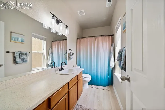 a bathroom with a sink a mirror and a shower