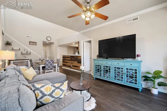 a living room with furniture and a flat screen tv