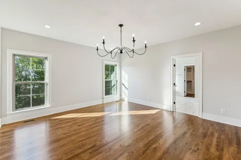 an empty room with a empty space and windows