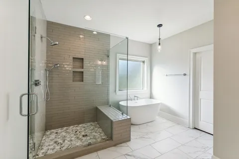 a bathroom with a glass shower door and a bathroom