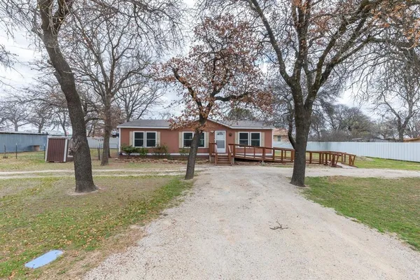 a view of a house with a yard covered in snow