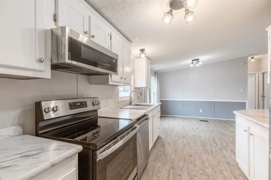 717 Marlin Street Clyde, TX 79510 - Photo 17 of 37 a kitchen with stainless steel appliances a sink a stove and a microwave