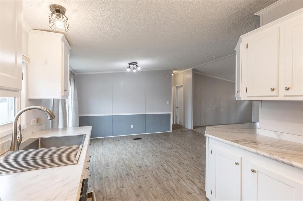 717 Marlin Street Clyde, TX 79510 - Photo 18 of 37 a kitchen with granite countertop a sink and a stove top oven