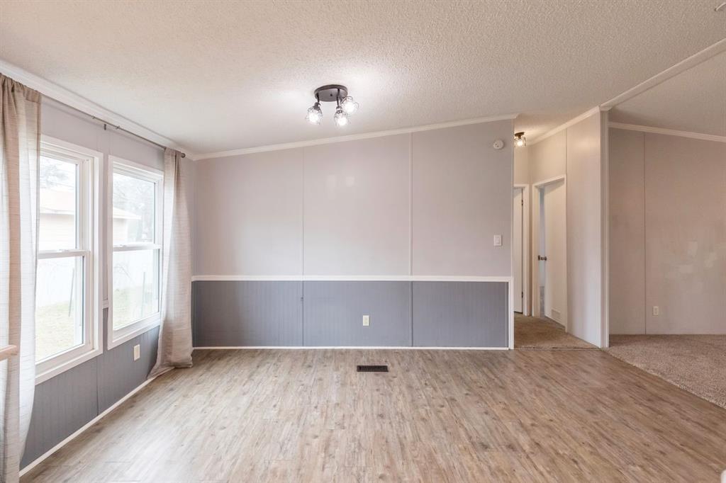 717 Marlin Street Clyde, TX 79510 - Photo 19 of 37 a view of an empty room with wooden floor and a window