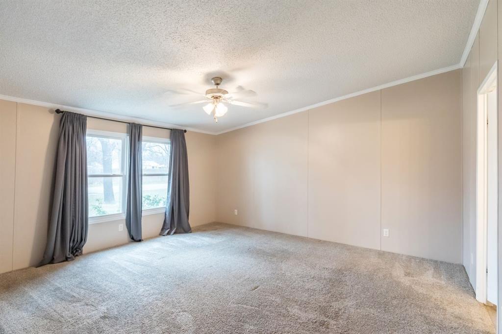 717 Marlin Street Clyde, TX 79510 - Photo 27 of 37 an empty room with windows and chandelier fan