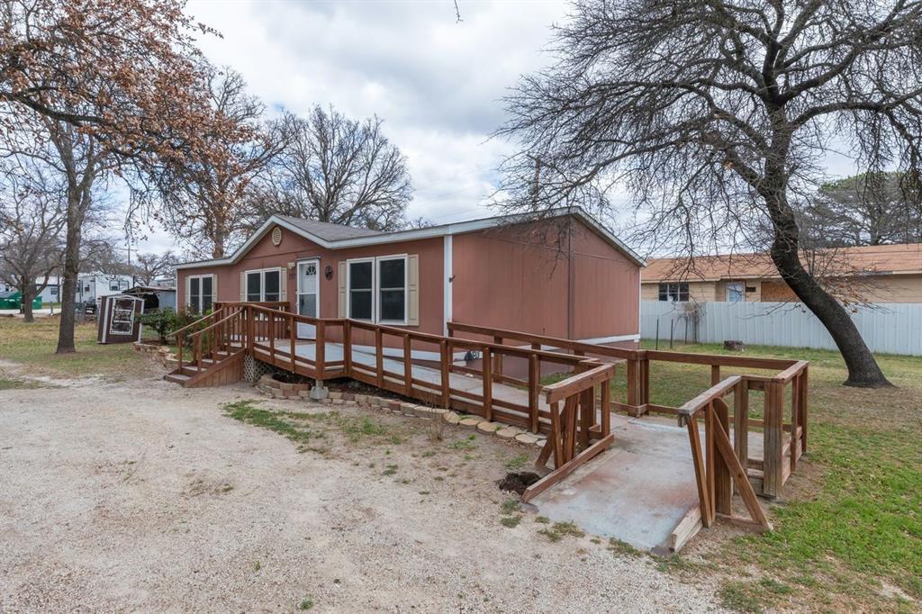 717 Marlin Street Clyde, TX 79510 - Photo 3 of 37 a view of house with outdoor seating area and trees
