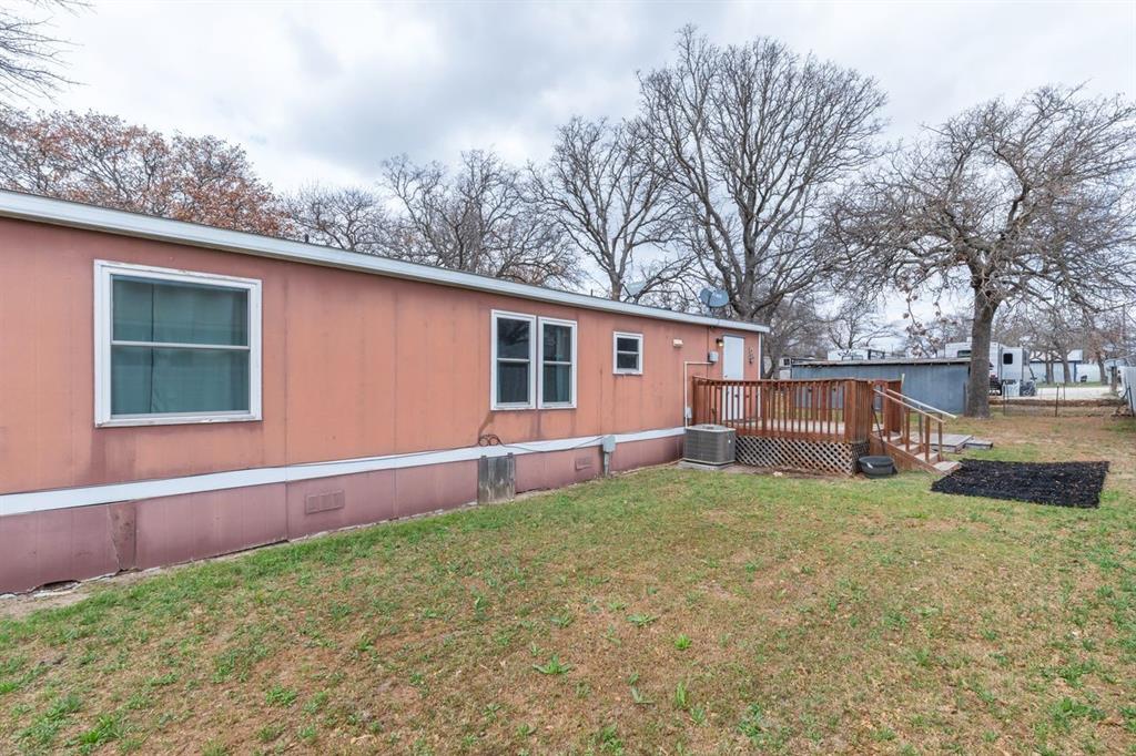 717 Marlin Street Clyde, TX 79510 - Photo 10 of 37 a view of a backyard with a house and large tree