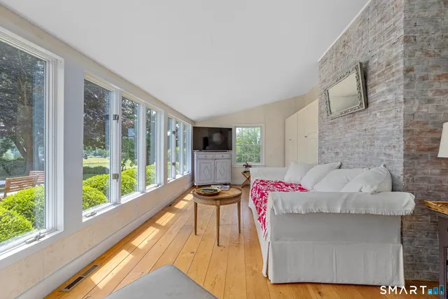 a living room with furniture and a floor to ceiling window
