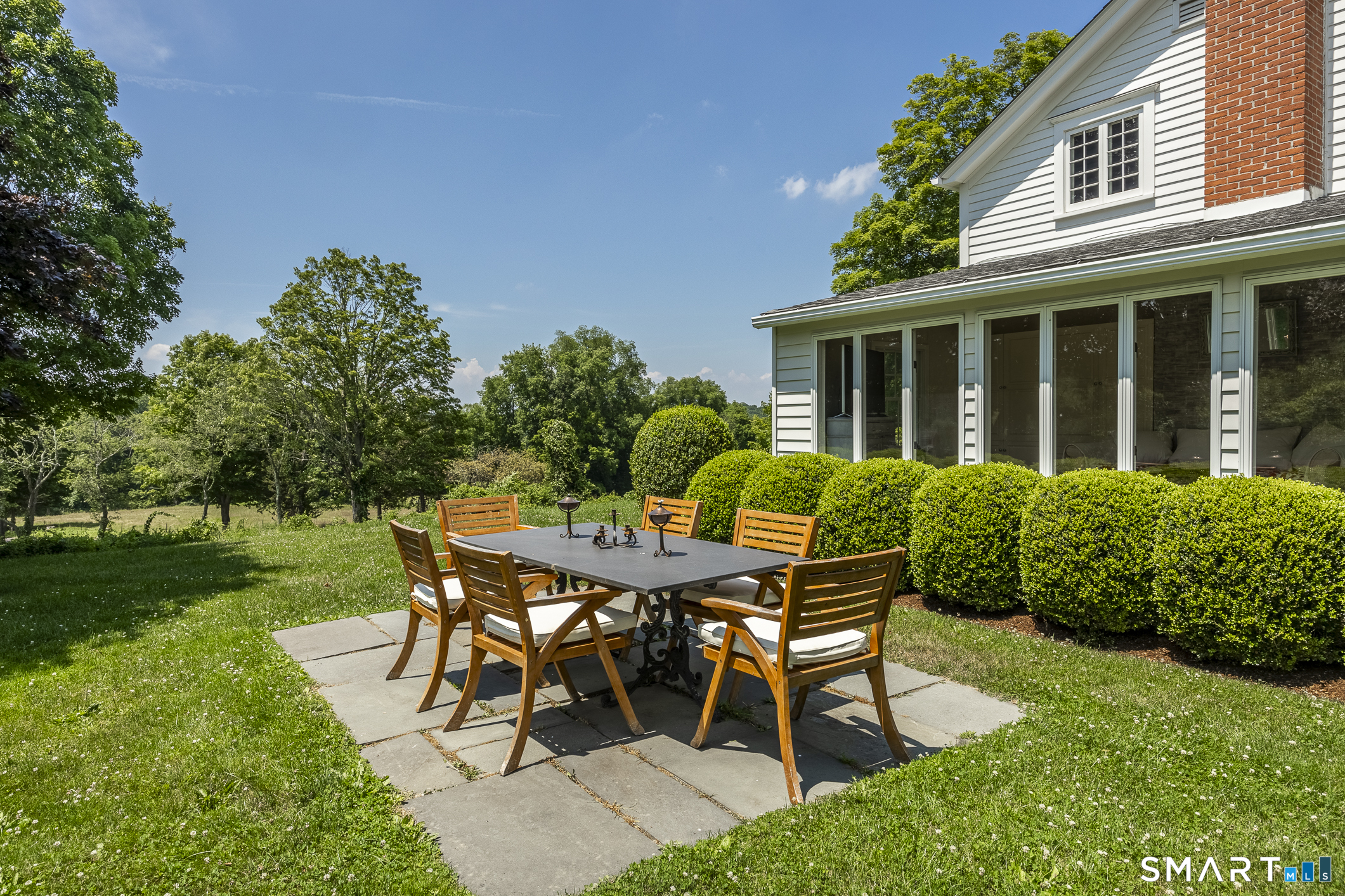 50 Warner Road Bridgewater, CT 06752 - Photo 25 of 27 a patio with table and chairs and potted plants