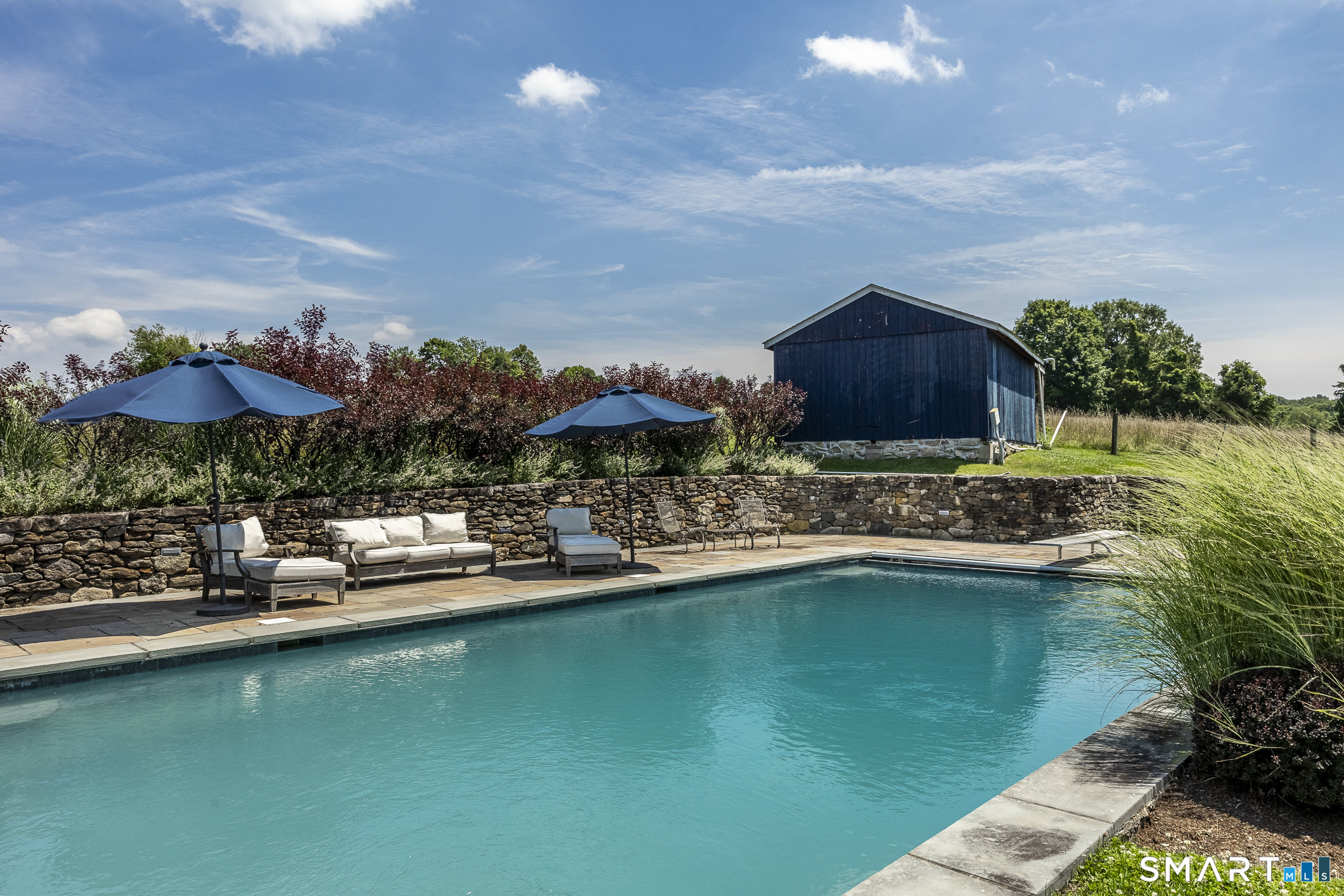 50 Warner Road Bridgewater, CT 06752 - Photo 26 of 27 a view of a swimming pool with a yard and sitting area