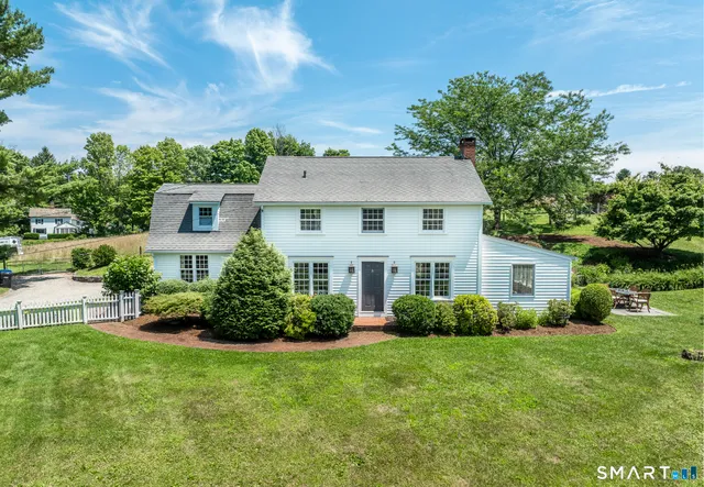 a front view of house with yard and green space