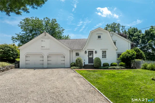 a view of a white house with a yard
