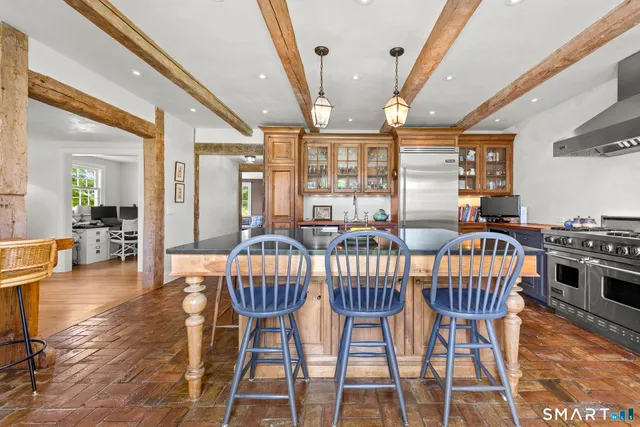 a dining room with furniture a chandelier and wooden floor