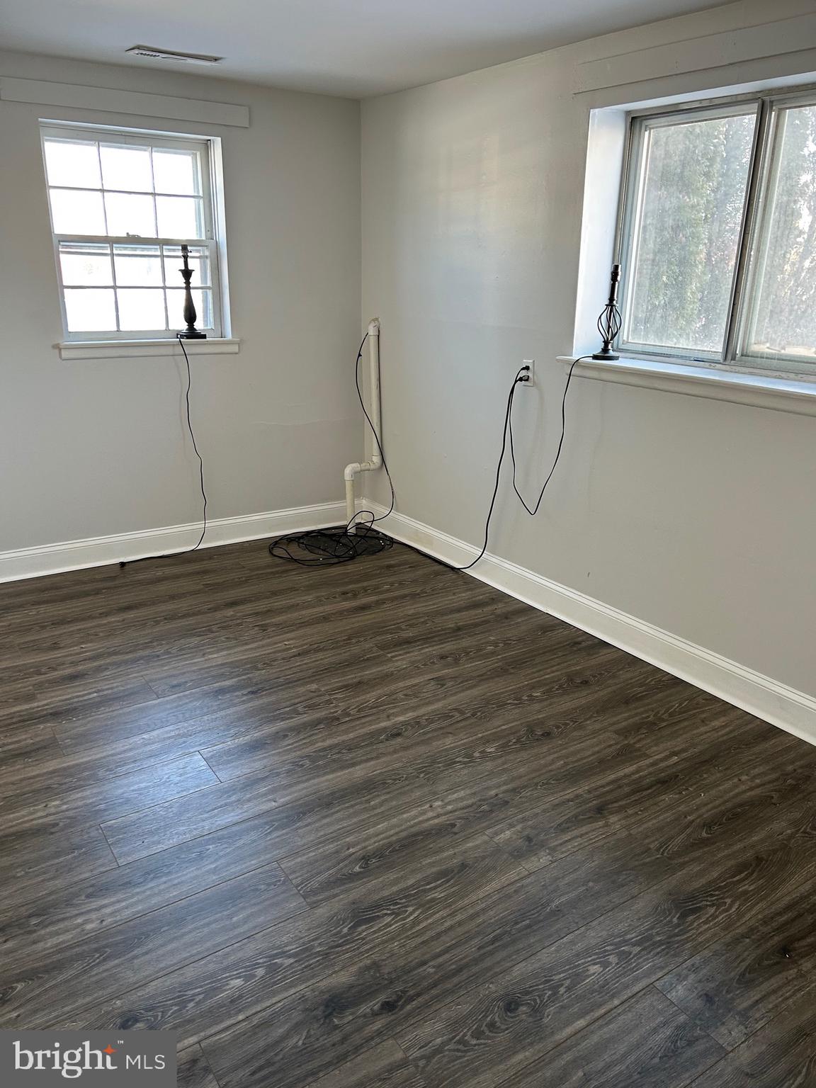 240 Purdue Avenue Pemberton, NJ 08068 - Photo 22 of 27 a view of an empty room with wooden floor and a window