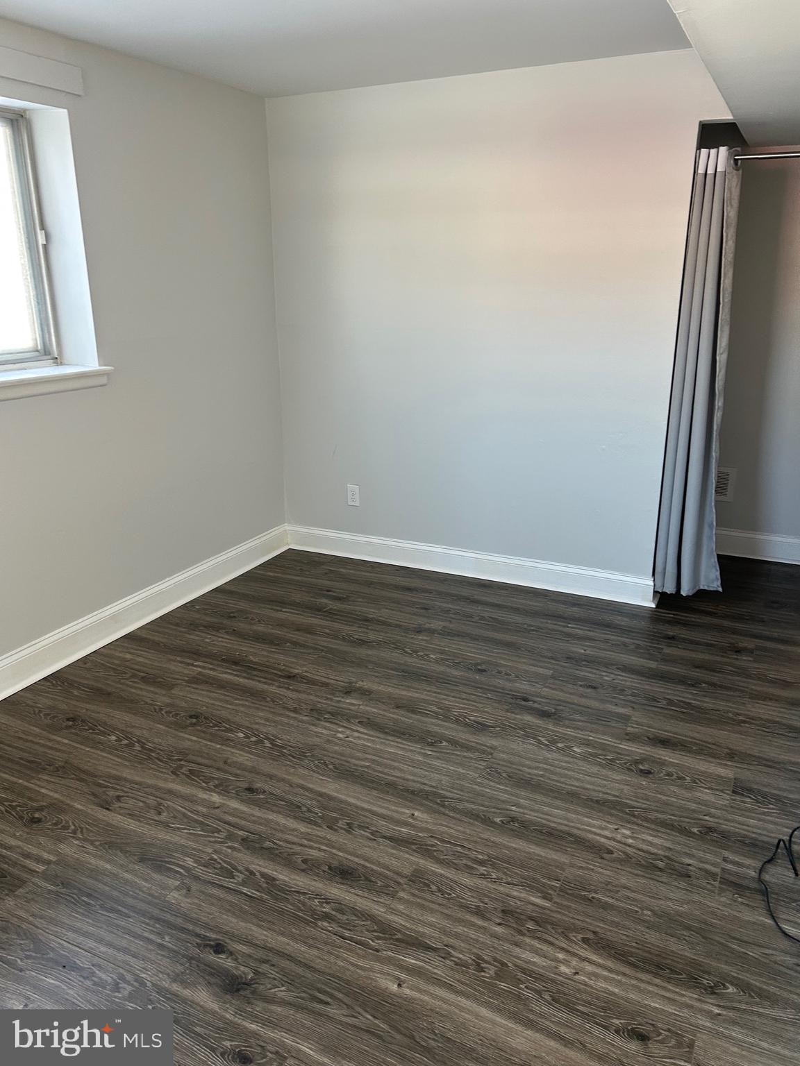 240 Purdue Avenue Pemberton, NJ 08068 - Photo 25 of 27 a view of an empty room with wooden floor and a window