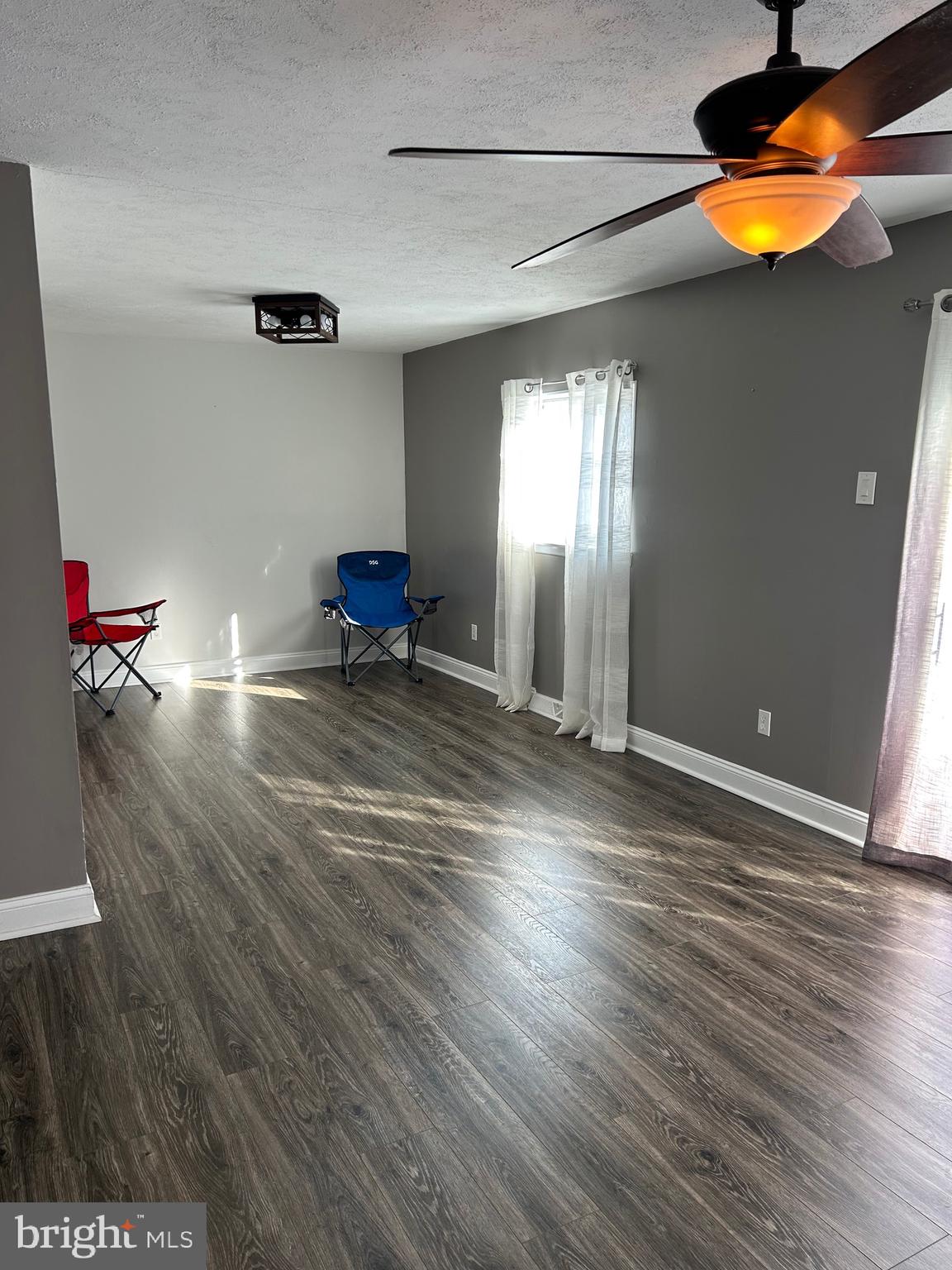 240 Purdue Avenue Pemberton, NJ 08068 - Photo 4 of 27 an empty room with wooden floor and windows