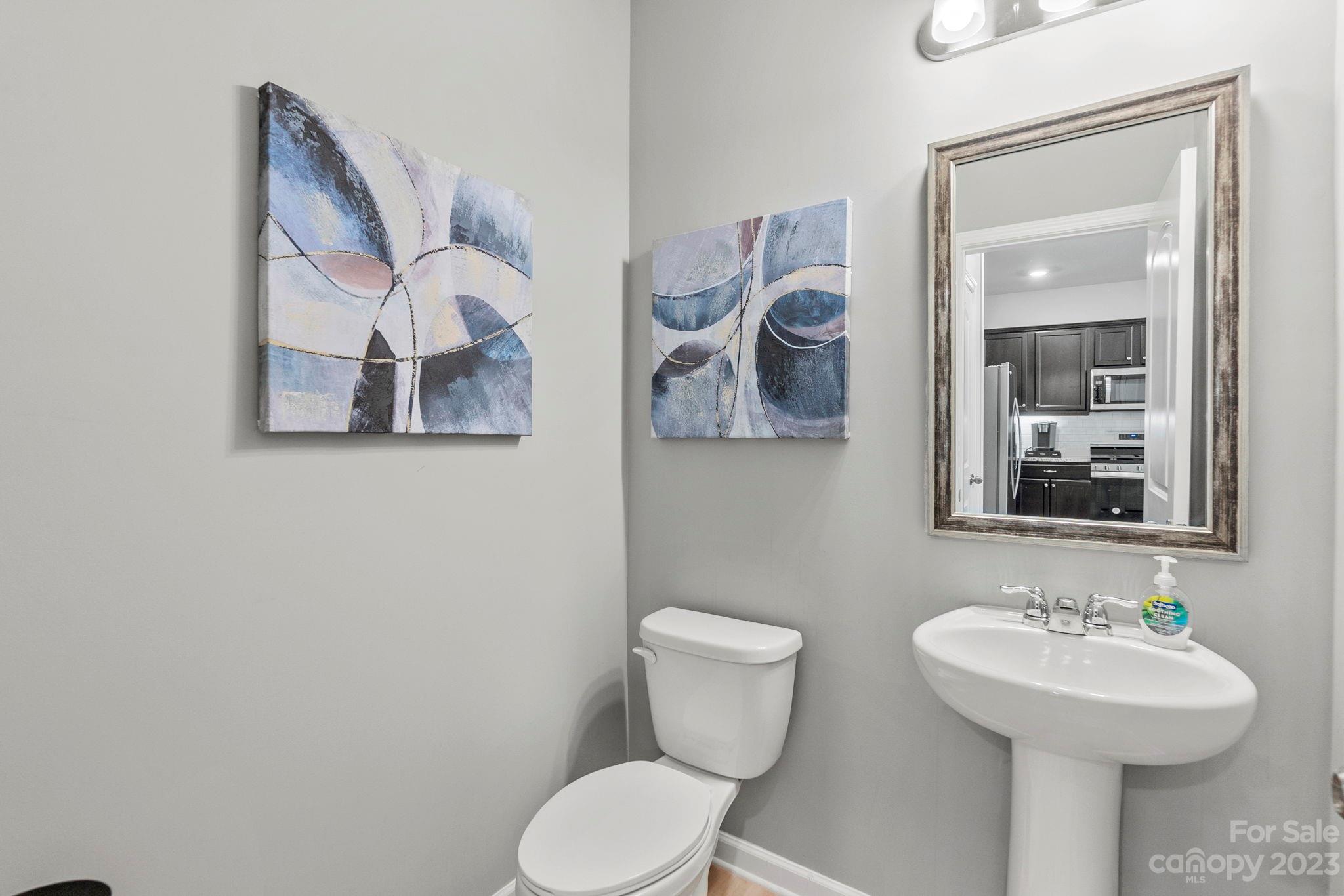 7856 Nelson Road Mint Hill, NC 28227 - Photo 11 of 30 a bathroom with a toilet sink and mirror