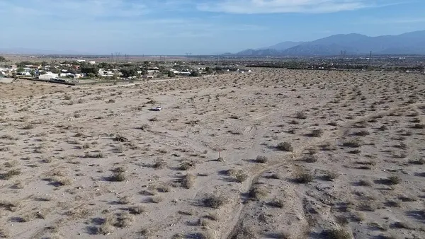a view of a field with an ocean
