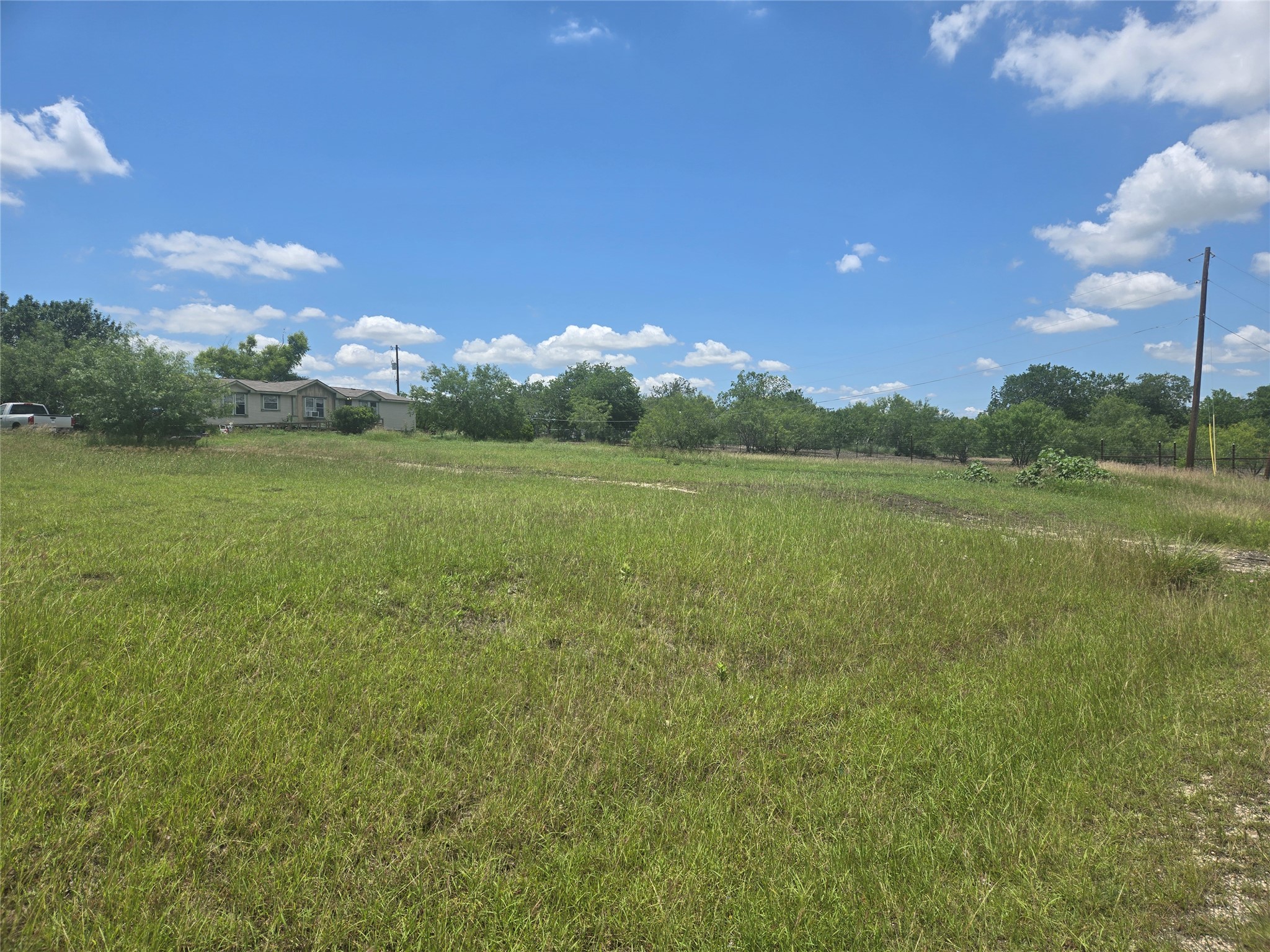 150 Longhorn Loop Kyle, TX 78640 - Photo 3 of 13 a view of a big yard with an outdoor space and seating