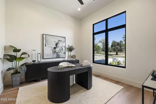 a kitchen with kitchen island granite countertop a sink a stove and cabinets