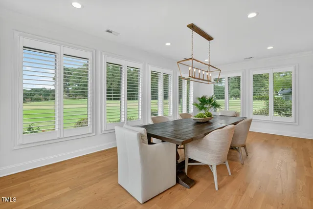 a dining room with furniture a chandelier and window