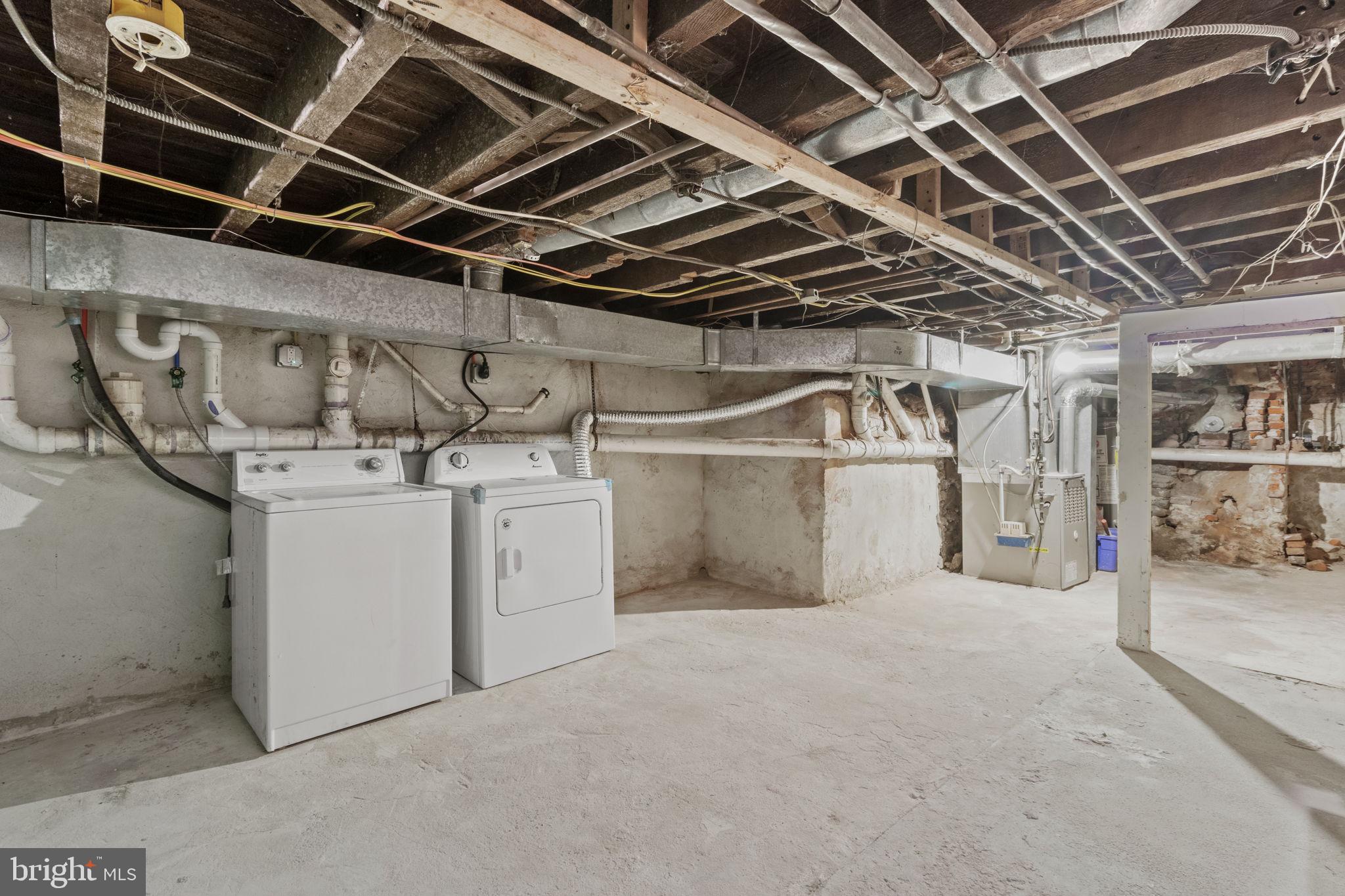 728 Christian Street, Unit 1 Philadelphia, PA 19147 - Photo 23 of 25 a utility room with dryer and racks