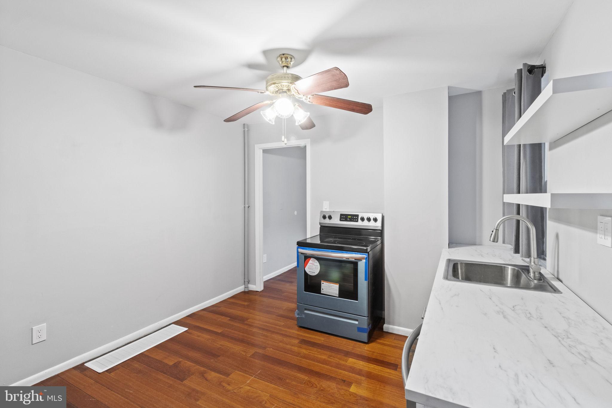 728 Christian Street, Unit 1 Philadelphia, PA 19147 - Photo 6 of 25 a view of kitchen and hall with wooden floor
