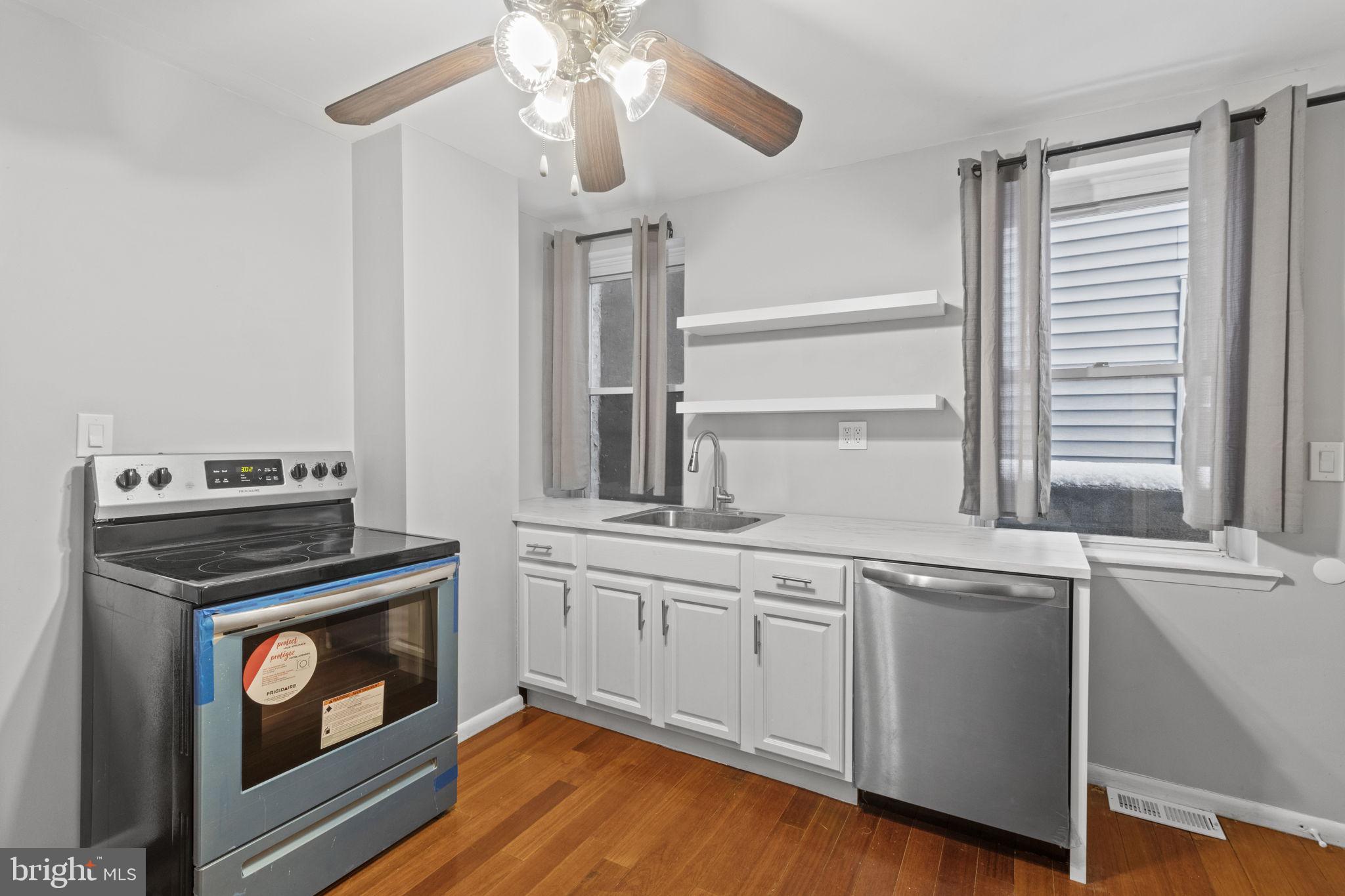 728 Christian Street, Unit 1 Philadelphia, PA 19147 - Photo 8 of 25 a kitchen with cabinets appliances and a window