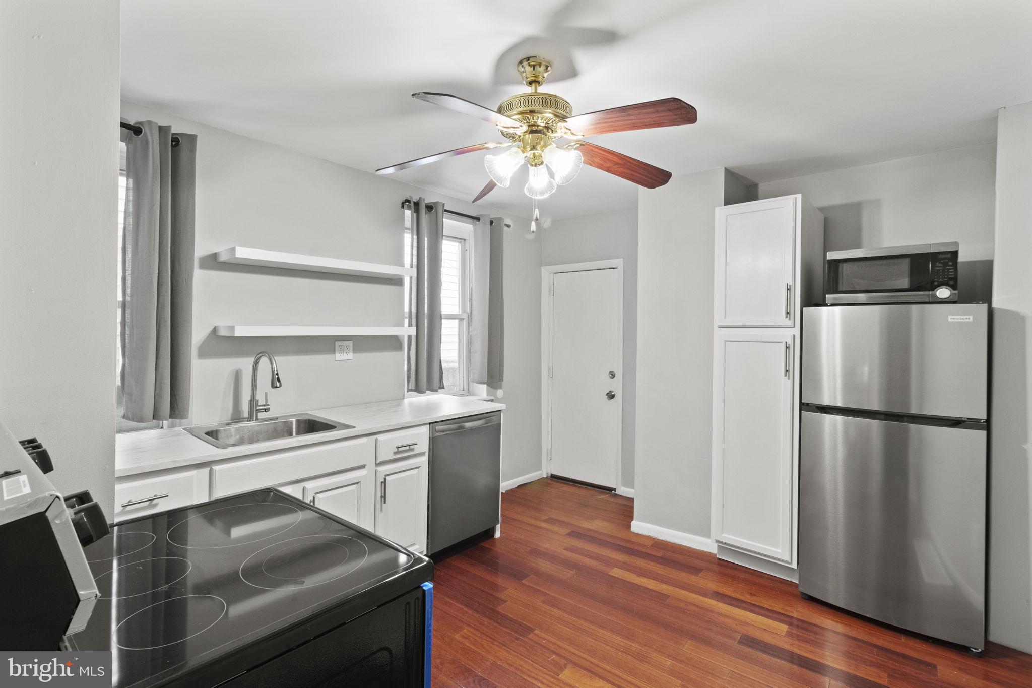 728 Christian Street, Unit 1 Philadelphia, PA 19147 - Photo 10 of 25 a kitchen with stainless steel appliances a stove a refrigerator and a chandelier