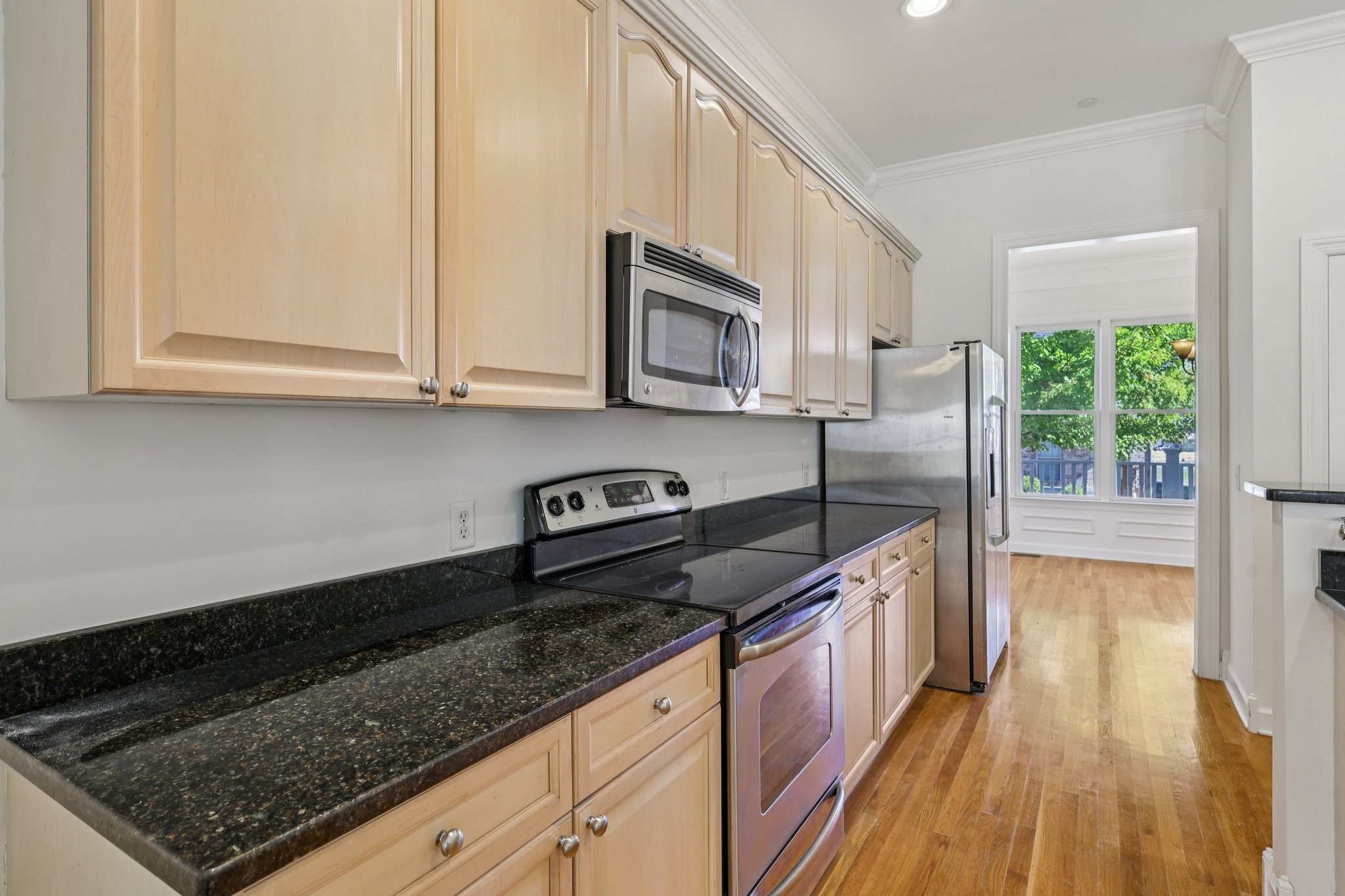 288 Augusta Avenue Pleasant View, TN 37146 - Photo 11 of 28 a kitchen with granite countertop a sink a stove top oven a counter space and cabinets
