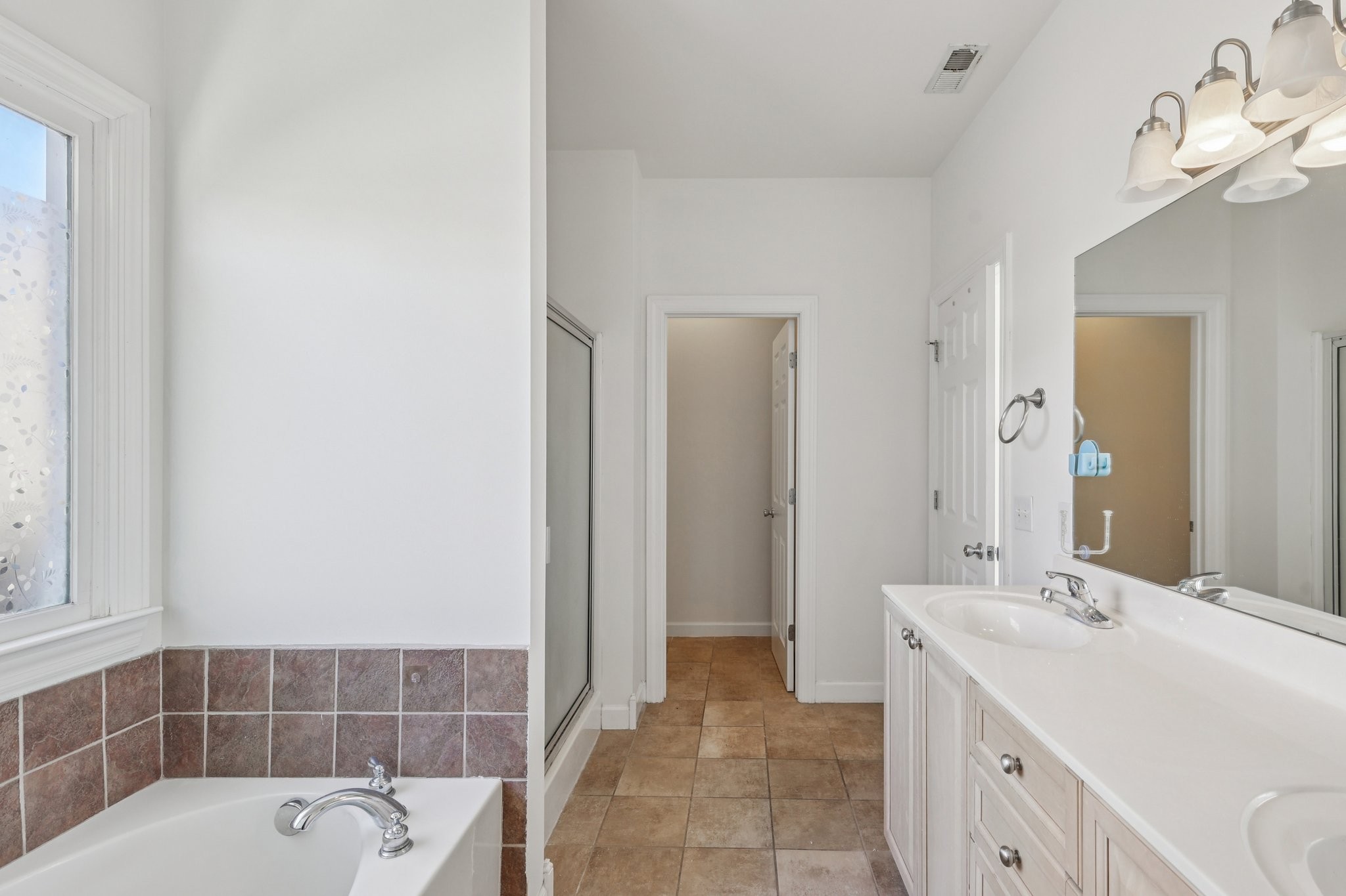 288 Augusta Avenue Pleasant View, TN 37146 - Photo 24 of 28 a bathroom with a tub sink and mirror