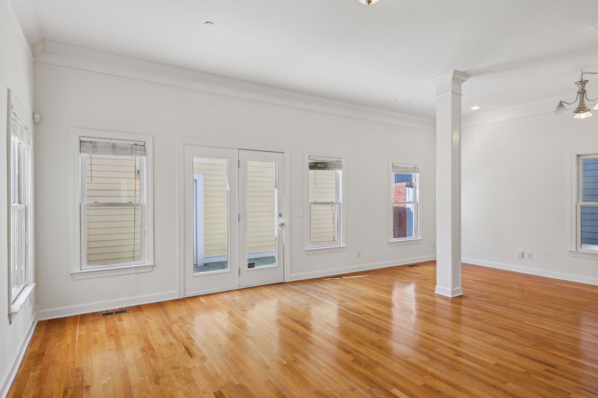 288 Augusta Avenue Pleasant View, TN 37146 - Photo 6 of 28 an empty room with wooden floor and windows