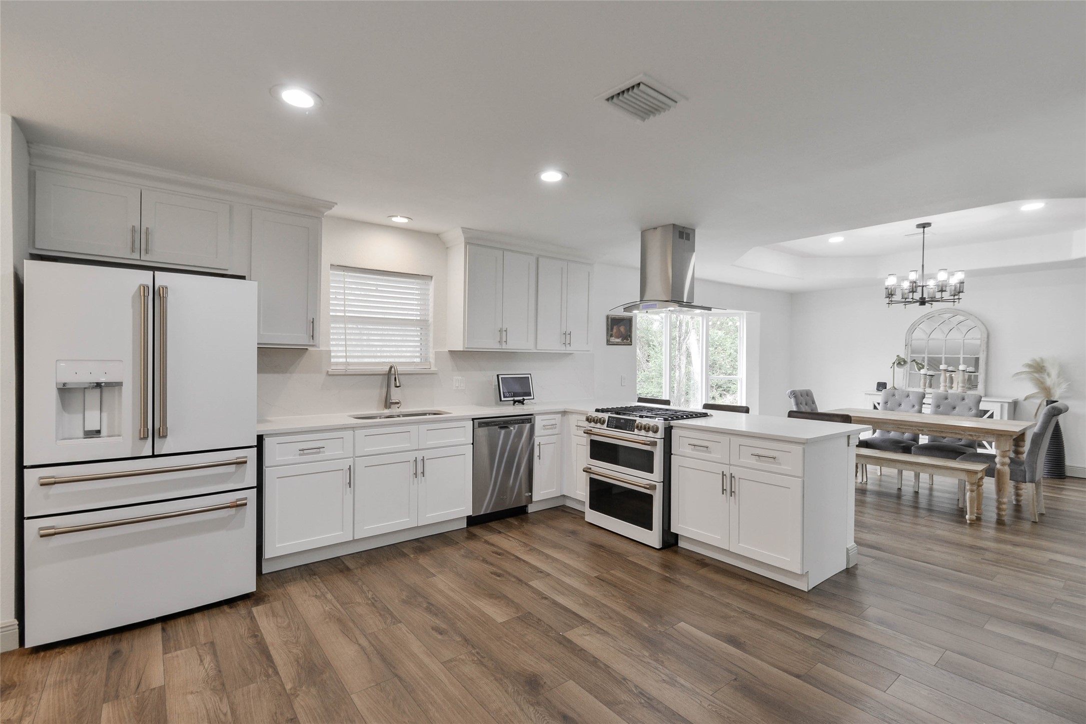 531 Brandon Road Conroe, TX 77302 - Photo 23 of 33 a kitchen with white cabinets appliances and wooden floor