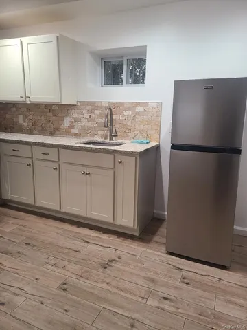a kitchen with stainless steel appliances granite countertop a refrigerator sink and cabinets