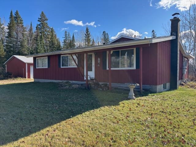 11452 Cooper Road Chisholm, MN 55719 - Photo 1 of 14 Ranch-style house featuring a front yard, a chimney, crawl space, and a garage