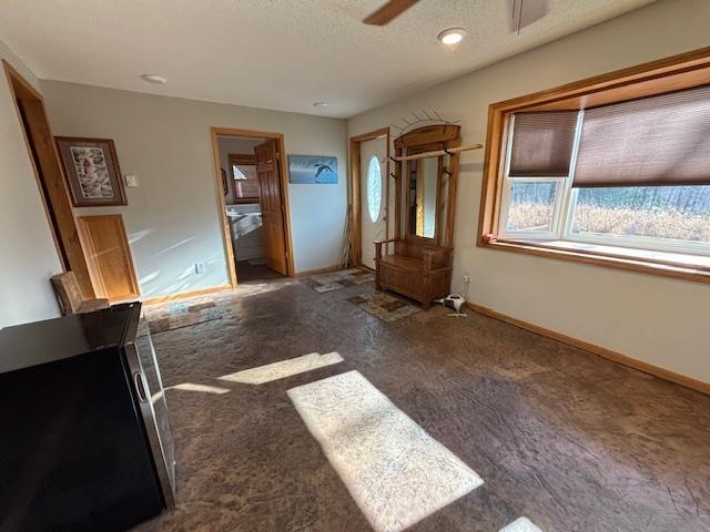 11452 Cooper Road Chisholm, MN 55719 - Photo 2 of 14 Spare room featuring a textured ceiling, a ceiling fan, and carpet floors