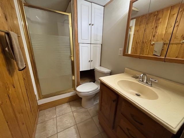 11452 Cooper Road Chisholm, MN 55719 - Photo 7 of 14 Full bathroom featuring a shower stall, vanity, light tile patterned flooring, and wood walls