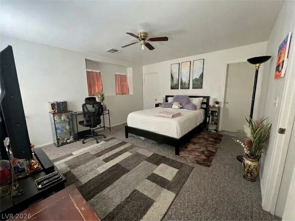 5698 Doubleday Street Las Vegas, NV 89118 - Photo 13 of 24 Carpeted bedroom with a desk and a ceiling fan