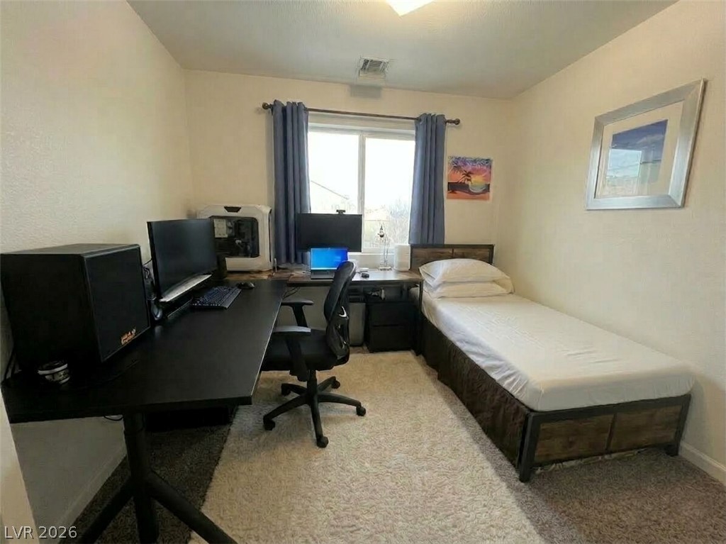 5698 Doubleday Street Las Vegas, NV 89118 - Photo 15 of 24 Bedroom with an office area and light colored carpet