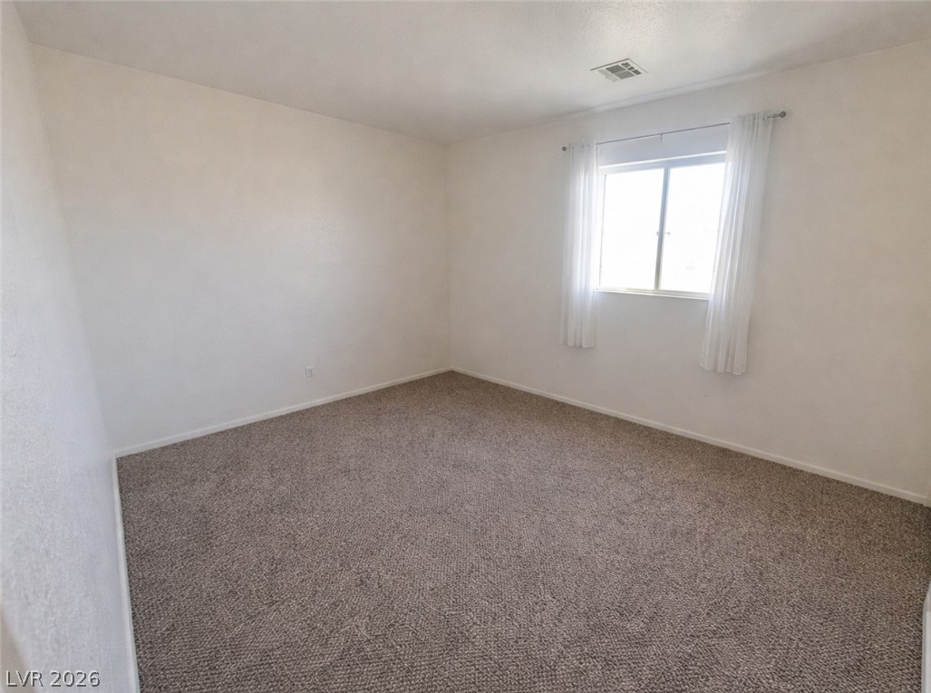 5698 Doubleday Street Las Vegas, NV 89118 - Photo 6 of 24 Unfurnished room featuring carpet floors and baseboards