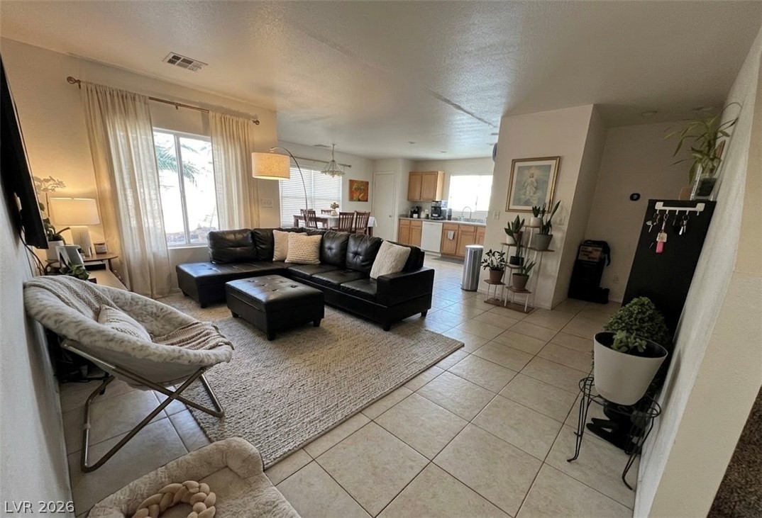 5698 Doubleday Street Las Vegas, NV 89118 - Photo 9 of 24 Living area with light tile patterned floors and a textured ceiling