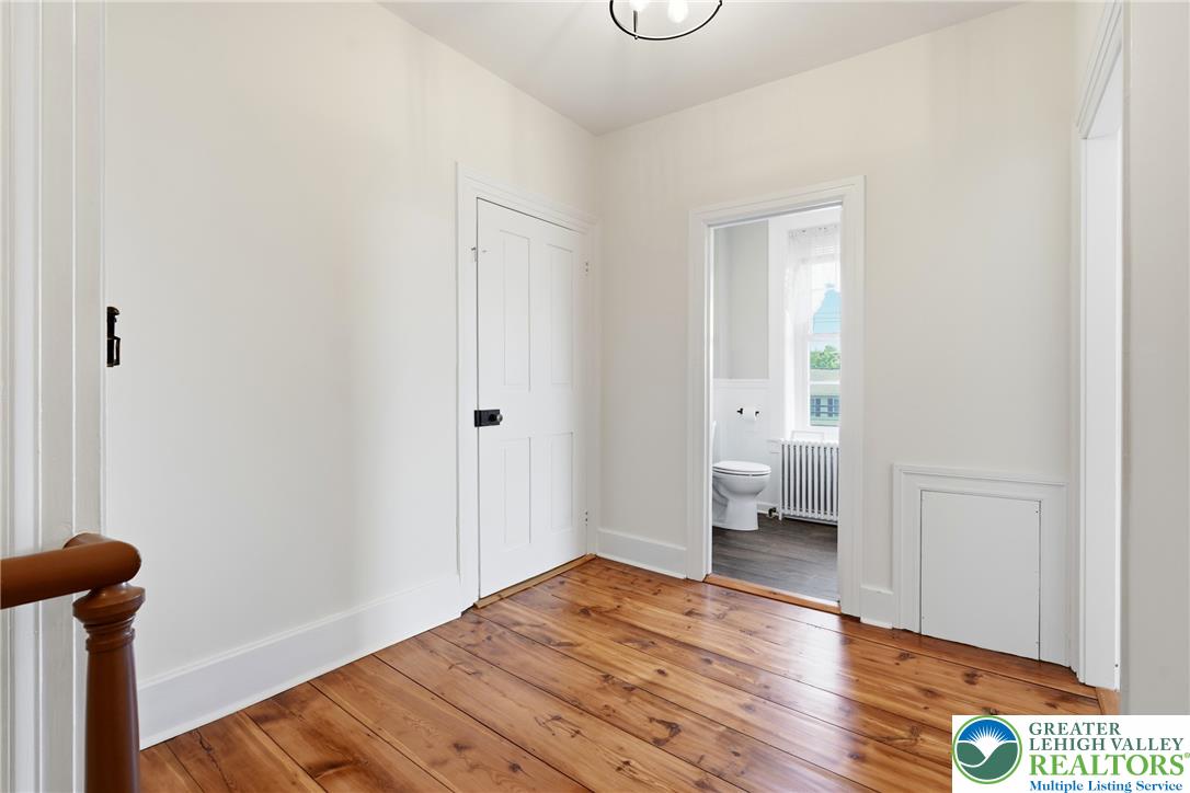 4682 Steuben Road Bethlehem, PA 18020 - Photo 24 of 79 Authentic wood plank flooring connects this hallway to a bright bathroom space.