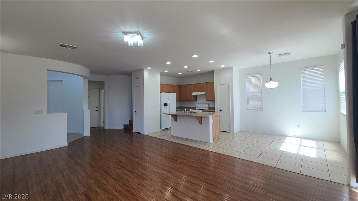 8944 Rutherford Grove Street Las Vegas, NV 89148 - Photo 35 of 35 An open floorplan seamlessly connects the well-appointed kitchen to ample living spaces.
