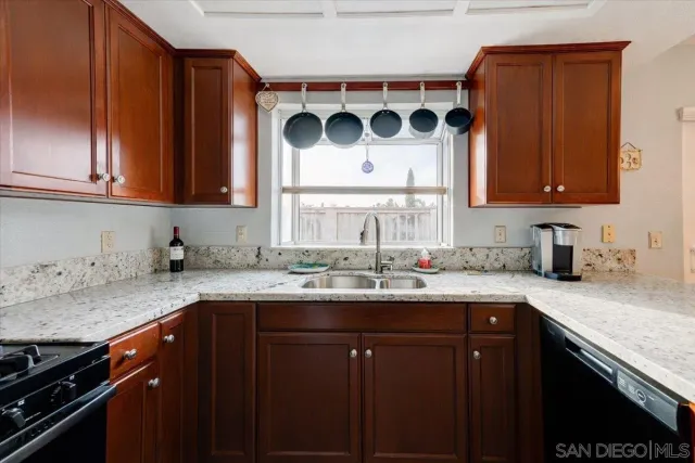 a bathroom with a sink a toilet a mirror a vanity and shower